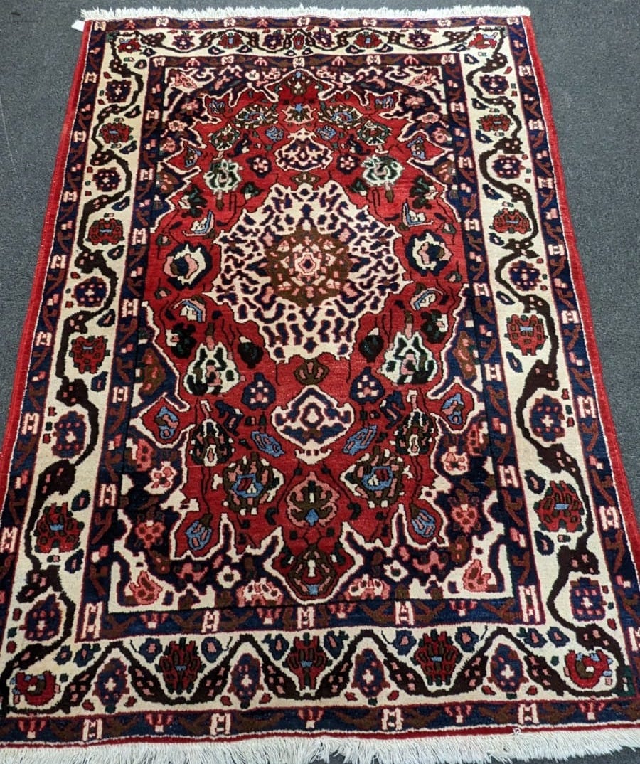 A Persian red ground rug, 204 x 151cm